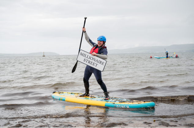 Man on a paddleboard celebrating